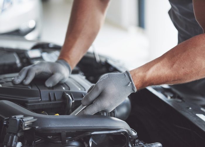 Auto mechanic working in garage. Repair service